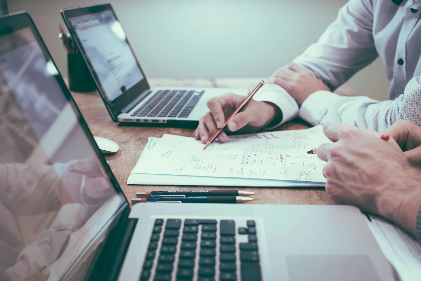 Accounting professionals reviewing client files and delivery plans